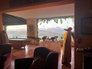a living room with a pool table and a large window at Ciuci's Manor in Aragona