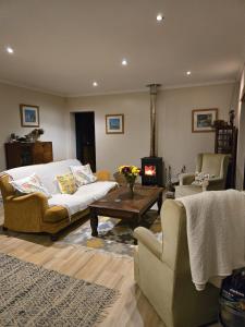 een woonkamer met een bank en een open haard bij Cherry Lane Constantia in Kaapstad +57 foto's