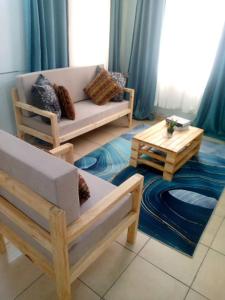 a living room with a couch and a coffee table at Bluezone Residence in Arusha