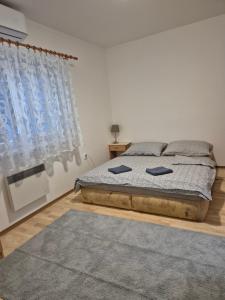 a bedroom with a bed with two pillows on it at Apartmany-Anna in Podhájska