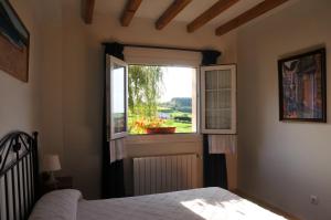 a bedroom with a bed and a window at Apartamentos Corona in Comillas