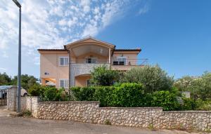 a large house behind a stone wall at Gorgeous Apartment In Razanj With Wifi in Ražanj