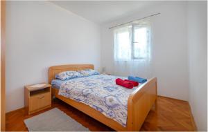 a small bedroom with a bed and a window at Gorgeous Apartment In Razanj With Wifi in Ražanj