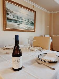 a bottle of wine sitting on top of a table at Doade in Hio