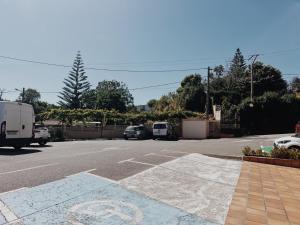 a street with cars parked in a parking lot at Doade in Hio