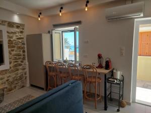 a kitchen and dining room with a table and chairs at Vaporia Stone House Seaview in Ermoupoli