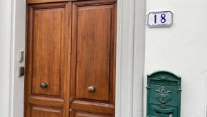 a wooden door and a sign on a building at affittacamere alloggio olivo Empoli a pochi passi dalla stazione in Empoli