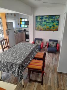 a living room with a large bed and a kitchen at El Chañar in Villa Carlos Paz
