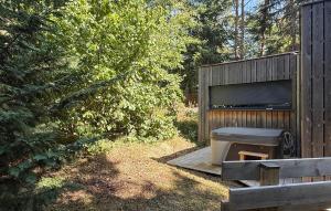 a wooden bench sitting next to a wooden fence at Lovely Home In Labaroche With Sauna in Labaroche +8 photos