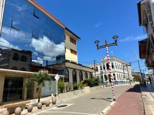 a street in a city with a cross on a pole at DORAL Inn in Iquitos