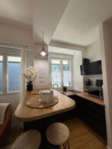 a kitchen with a table with a cake on it at L'Escapade Choletaise in Cholet +13 photos