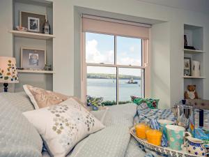 a living room with a couch and a large window at Haven View in Neyland