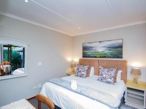 a bedroom with a bed in a room with a window at Eikelower Accommodation in Stellenbosch +13 photos