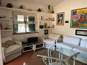 a living room with two couches and a table at Villa Benedetta in Parghelia
