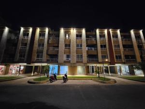 two motorcycles parked in front of a building at night at Monoambiente Azopardo in Formosa