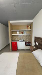 a bedroom with a bed and a kitchen with a sink at Monoambiente Azopardo in Formosa
