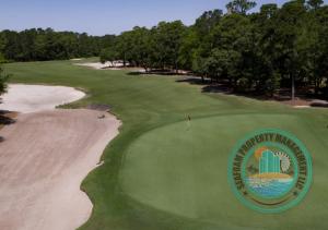 a view of a golf course with the championship club logo on the green at 2Br 2Ba Condo on Golf Course in Pawleys Island