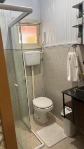a small bathroom with a toilet and a sink at Morada da Floresta in Gramado