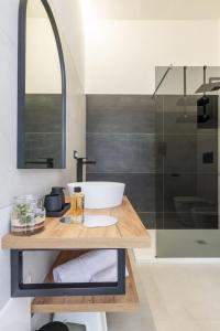 a bathroom with a sink and a glass shower at EnSe Affittacamere in Tortolì