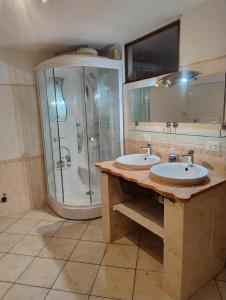 a bathroom with two sinks and a shower at Antico Arco in Montalto Ligure