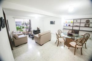 a living room with a table and chairs at Suites Lafragua in Veracruz