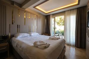 Postel nebo postele na pokoji v ubytování Roas Hotel Bodrum - City Center + 37 fotografií