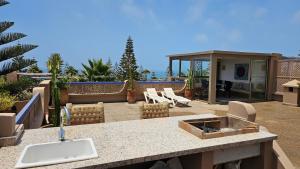 a patio with a sink and a counter top at Villa vue mer imprenable- charme et tranquillité in Sidi Boulfdail +41 photos