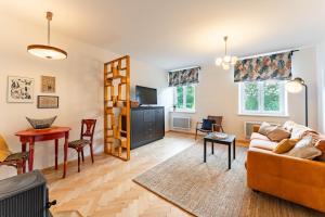 a living room with a couch and a table at Byteček v parku in Šumperk