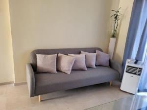 a couch with four pillows on it in a room at Alojamiento Vista Hermosa in Ayamonte