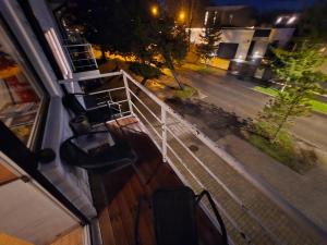 a balcony of a house with a fence and a street at Ranna Resort Hostel in Pärnu