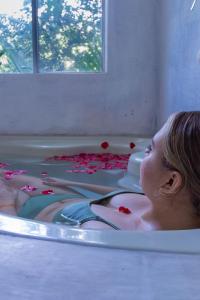 a woman laying in a bathtub filled with blood at Ecosoul Bugambilia villa in Puerto Vallarta