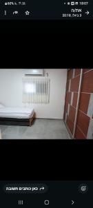 a picture of a room with a bed and a radiator at הבית של רביבו in Sderot