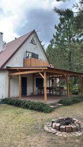 a pavilion with a picnic table and a fire place at Kisielkowo in Wilkasy