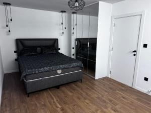 a bedroom with a bed and a mirror at Sarajevo Soul in Sarajevo