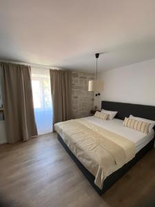 a bedroom with a large bed and a window at Cukarin Heritage in Korčula
