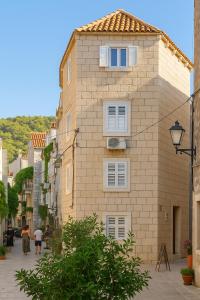 a large brick building on a city street at Cukarin Heritage in Korčula