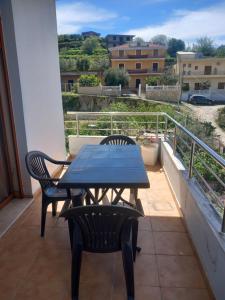 a table and chairs on a balcony with a view at Dario's Apartaments in Orikum