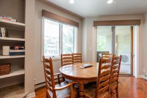 a dining room with a wooden table and chairs at Strawberry Park Condos feature Ski-In Ski-Out and Outdoor Heated Pool condo in Beaver Creek