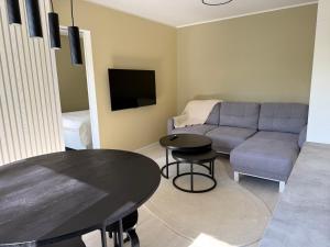 a living room with a couch and a table at Pargi külaliskorter in Jõgeva