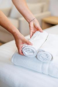 a person is rolling towels on a table at Hotel Juza in Borsh