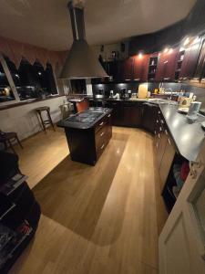 a kitchen with a island in the middle of a room at Ranna Resort Hostel in Pärnu