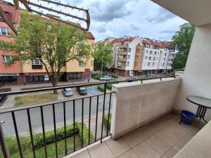 a balcony with a table and a view of a city at Mieszkanie w centrum blisko jeziora in Ostróda