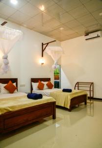 two beds in a room with two beds sidx sidx sidx sidx at EverGreen Resort Udawalawe in Udawalawe