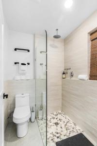 a bathroom with a toilet and a glass shower at Covelet Hideaway in Blaine