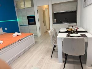 a room with a bed and a table and chairs at Residenz am Luganersee mit Pool in Bissone +9 photos