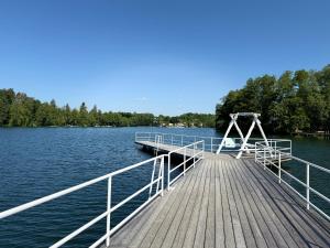 a dock on a lake with trees in the background at Domek nad jeziorem Łagów - Mundi, Lake Park in Łagów