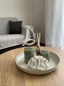 a table with a plate with towels and a couch at Philoxenia Apartments 2 in Samos