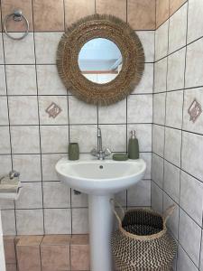 a bathroom with a sink and a mirror at Philoxenia Apartments 2 in Samos