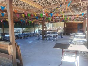a room with tables and chairs and colorful kites at Hotel Restaurant du Pont de Ners in Boucoiran-et-Nozières