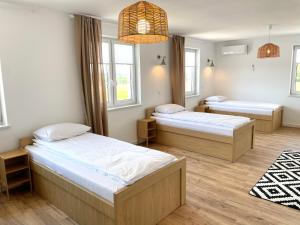 a bedroom with two beds and a chandelier at MAGURSKA PANORAMA l samodzielne zameldowanie l self check-in in Chrząstówka
